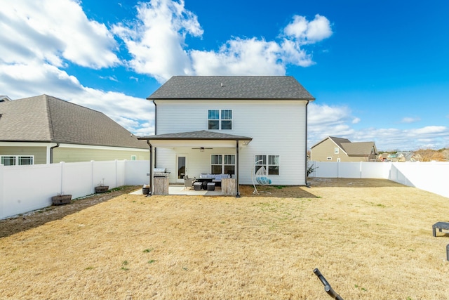 rear view of property featuring a patio area, a fenced backyard, a lawn, and ceiling fan