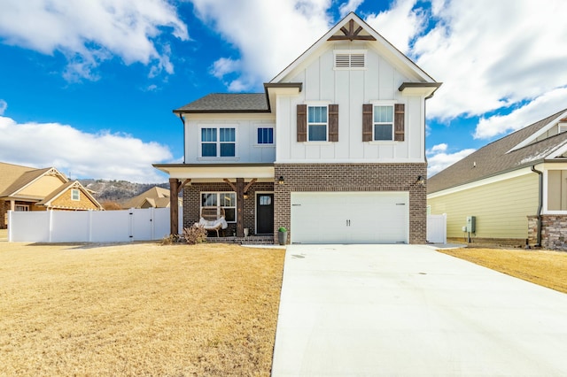 view of front of house featuring driveway, an attached garage, fence, board and batten siding, and brick siding