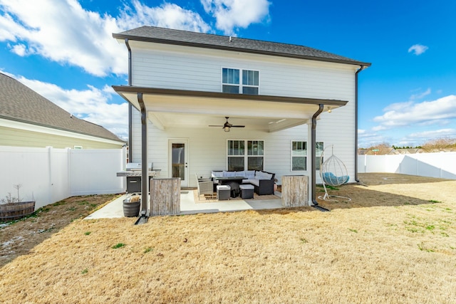 rear view of property with a yard, an outdoor hangout area, a patio area, ceiling fan, and a fenced backyard