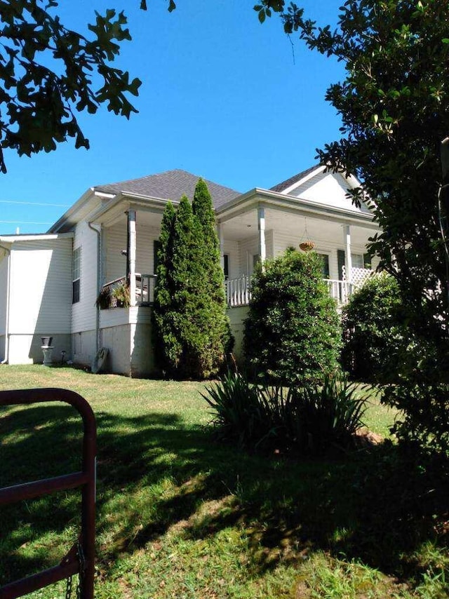 view of side of home featuring a lawn