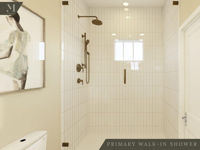 bathroom featuring a stall shower and toilet