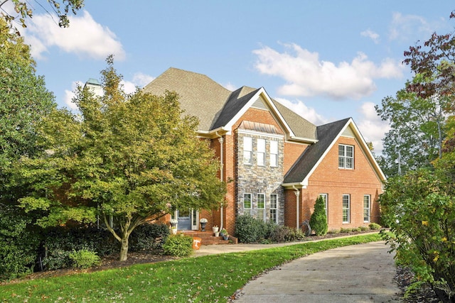 view of front of property with brick siding and a chimney