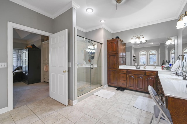 ensuite bathroom with a stall shower, crown molding, a sink, and tile patterned floors