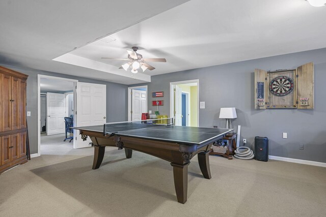 recreation room with light carpet, ceiling fan, and baseboards