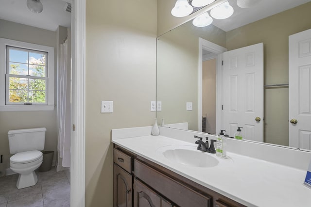 bathroom with toilet, tile patterned flooring, visible vents, and vanity