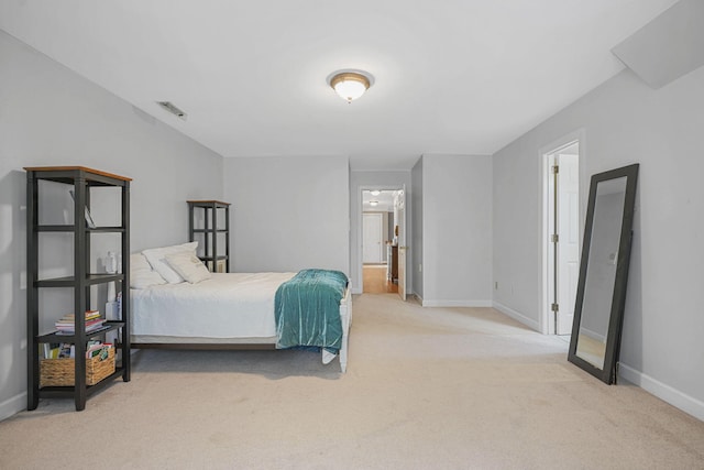 bedroom with carpet floors, visible vents, and baseboards