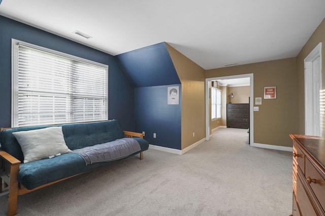 sitting room featuring light carpet, plenty of natural light, visible vents, and baseboards