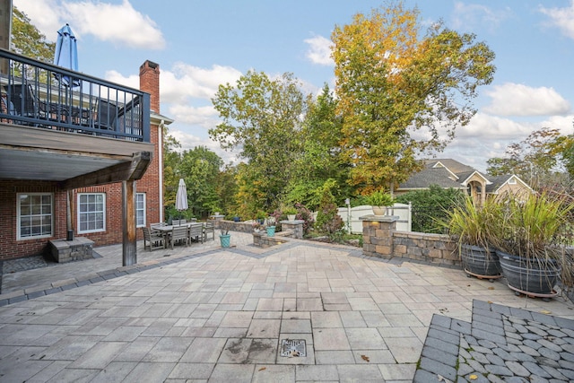 view of patio with outdoor dining space and a balcony