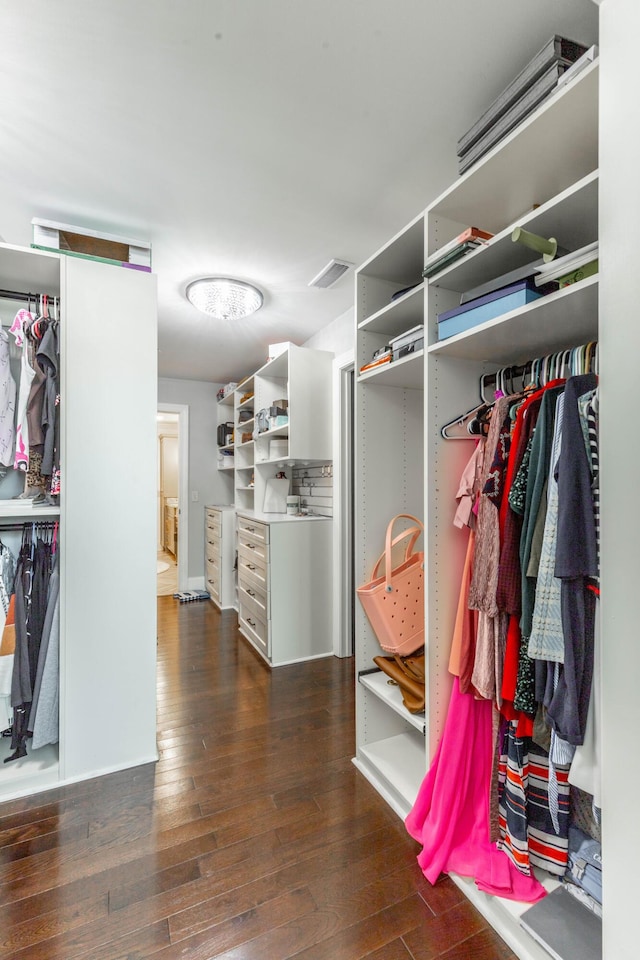 spacious closet with dark wood finished floors and visible vents