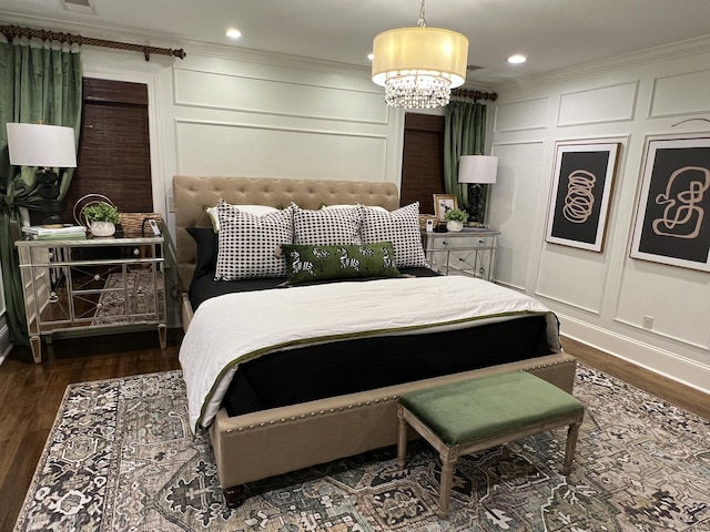 bedroom featuring crown molding, a decorative wall, and dark wood-type flooring