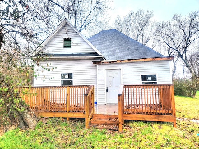 rear view of property featuring a deck