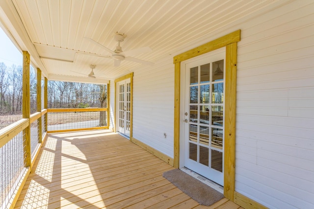 wooden deck with a ceiling fan and french doors