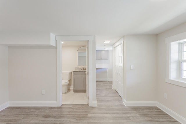 empty room with baseboards and light wood-style floors