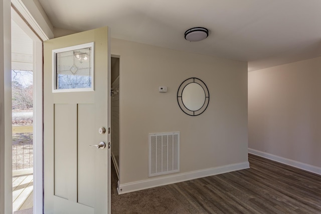 entryway featuring dark wood-style floors, visible vents, and baseboards