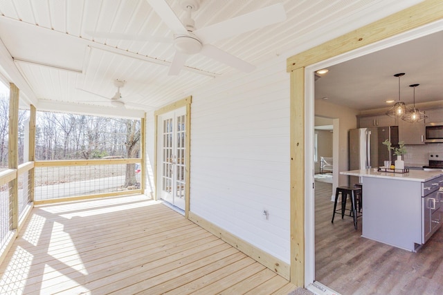 deck featuring french doors, ceiling fan, and outdoor dry bar