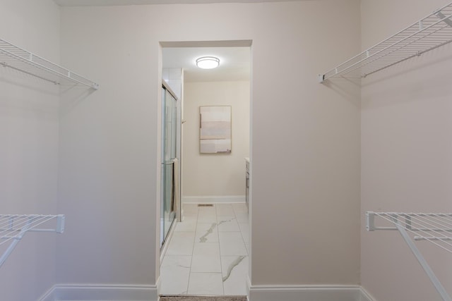 spacious closet with marble finish floor