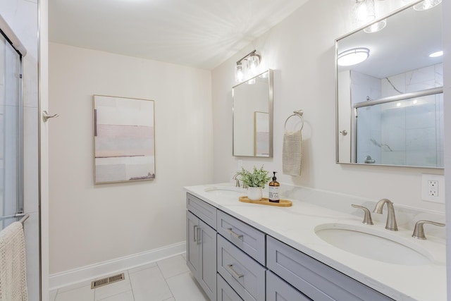 bathroom with double vanity, a stall shower, a sink, and visible vents