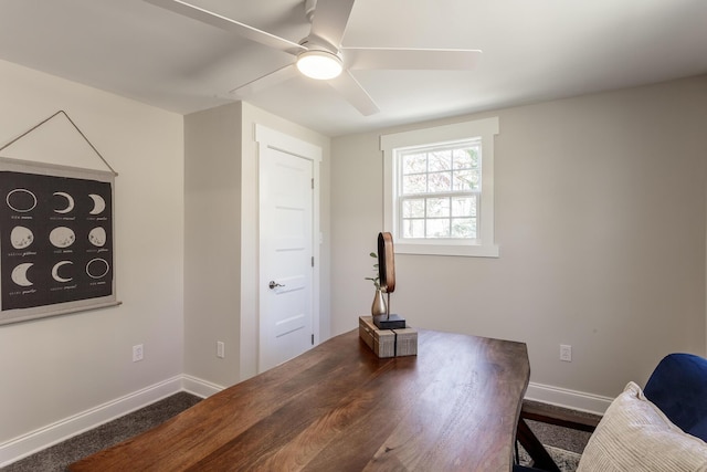 home office with a ceiling fan and baseboards