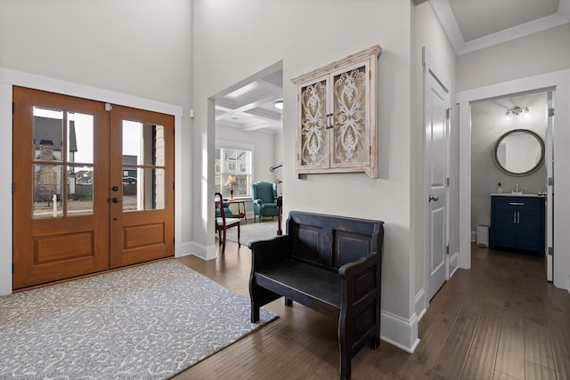 entryway with dark wood-type flooring, sink, beam ceiling, coffered ceiling, and crown molding