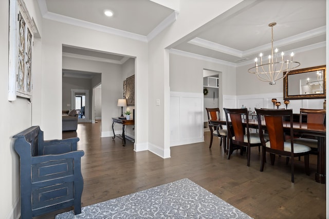 dining room featuring dark wood-type flooring, a chandelier, and crown molding