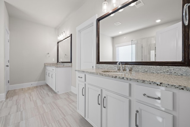 bathroom with vanity and an enclosed shower