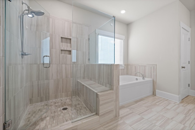 bathroom featuring shower with separate bathtub