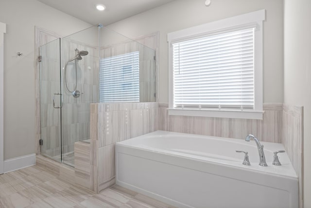 bathroom with shower with separate bathtub