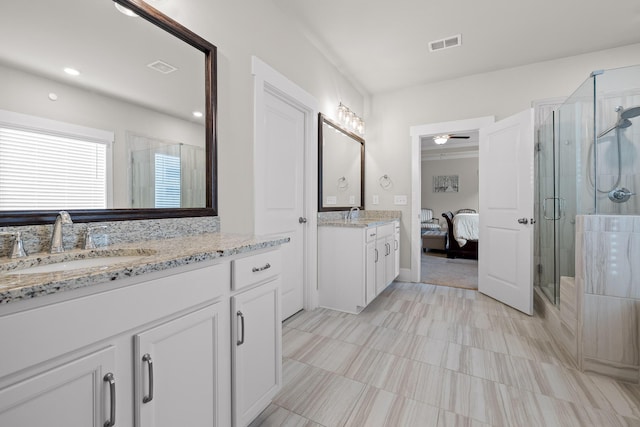 bathroom with vanity, a shower with door, and ceiling fan