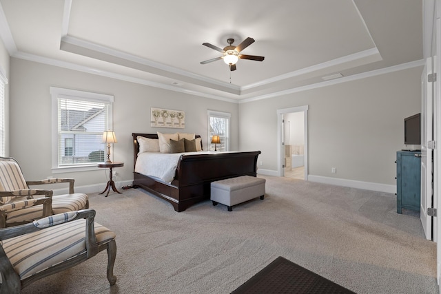 carpeted bedroom with ceiling fan, crown molding, a tray ceiling, and multiple windows