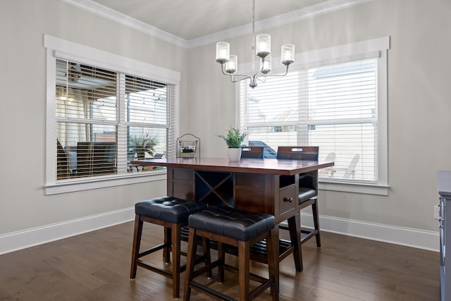 dining space featuring ornamental molding, dark hardwood / wood-style flooring, and a wealth of natural light