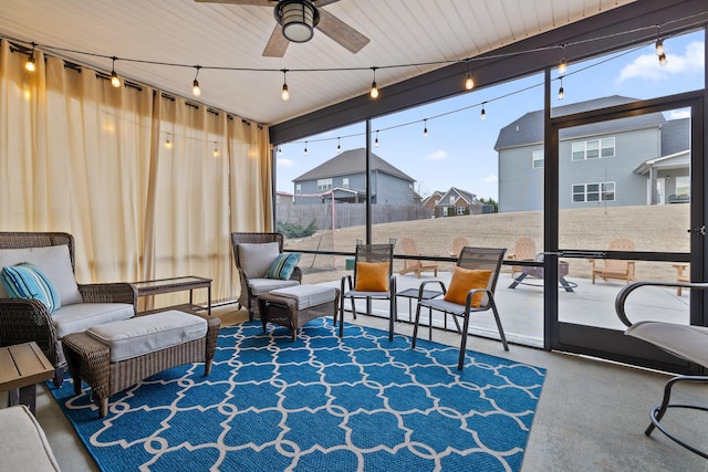 sunroom / solarium featuring track lighting and ceiling fan