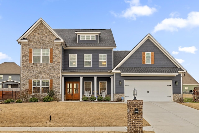 craftsman-style house featuring a front lawn, a porch, and a garage