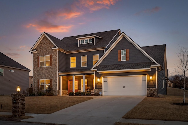 craftsman-style home with a garage, stone siding, and concrete driveway