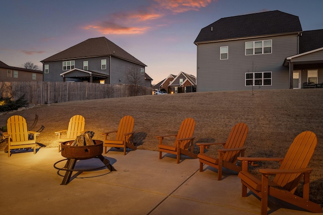 patio terrace at dusk featuring an outdoor fire pit