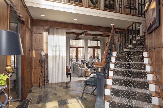 stairs featuring recessed lighting, french doors, stone tile flooring, and beamed ceiling