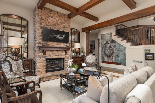 living room with a fireplace, beamed ceiling, decorative columns, and stairs