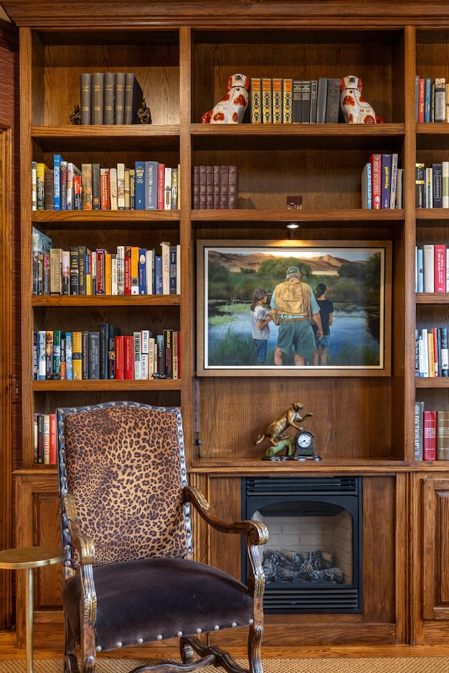 living area featuring a fireplace and built in features