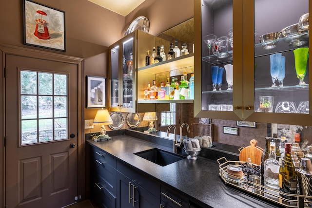 bar with wet bar, a sink, and decorative backsplash