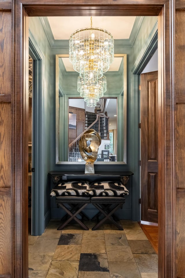 wine room with a chandelier, stone finish flooring, and crown molding