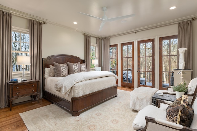 bedroom featuring multiple windows, wood finished floors, and recessed lighting