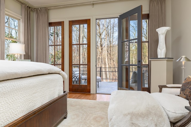 bedroom featuring light wood-type flooring and access to exterior