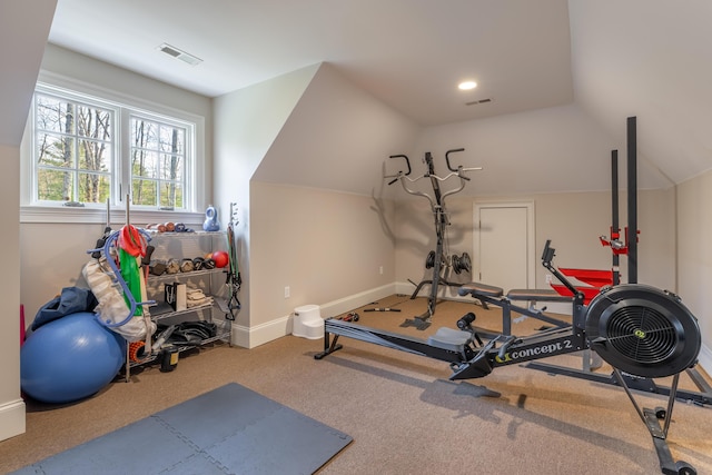 exercise area with vaulted ceiling, carpet flooring, visible vents, and baseboards