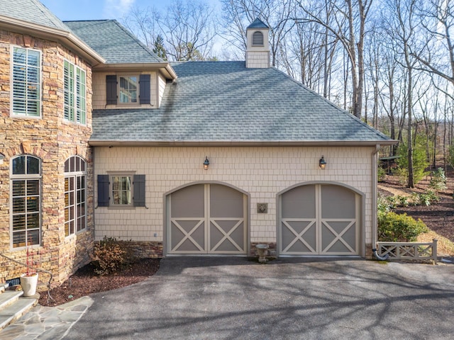 garage with aphalt driveway