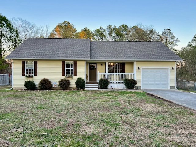 ranch-style house featuring a garage, a shingled roof, a front yard, and fence