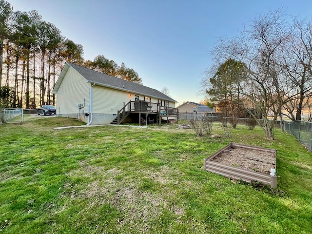 view of yard with stairway, a garden, a fenced backyard, and a wooden deck