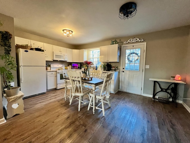 dining space with baseboards and dark wood-type flooring