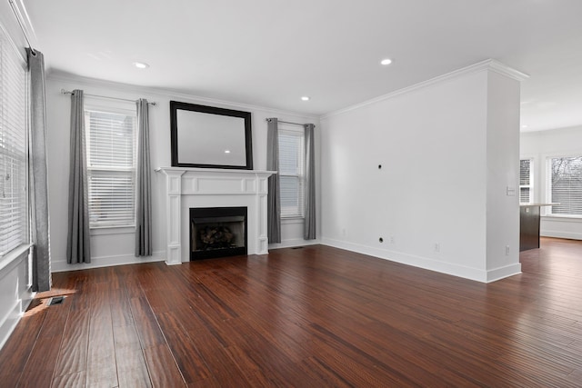 unfurnished living room featuring a fireplace, ornamental molding, dark wood finished floors, and recessed lighting