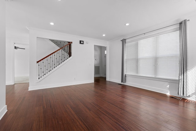 interior space featuring dark wood-type flooring, visible vents, ornamental molding, and stairs