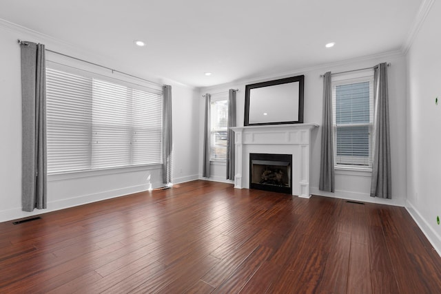 unfurnished living room with dark wood-style floors, visible vents, a fireplace, and ornamental molding