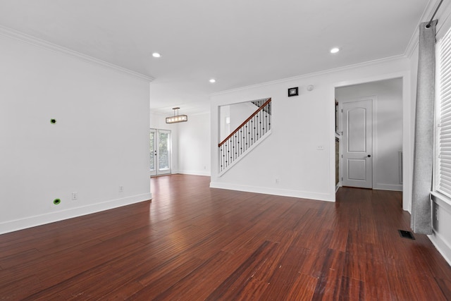 unfurnished living room featuring visible vents, baseboards, stairway, dark wood finished floors, and crown molding